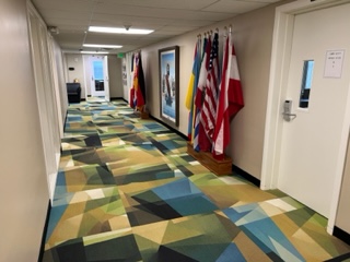 Flags of different countries surround a painting of Jesus in a hallway of Lynn wood hall outside the offices of the Modern Languages department. 