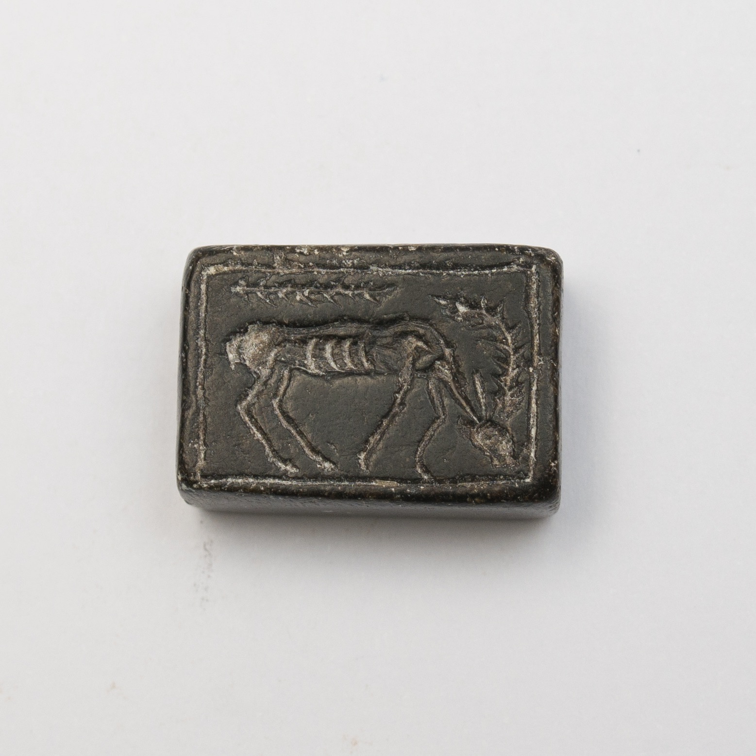a rectangular seal featuring the image of a grazing animal