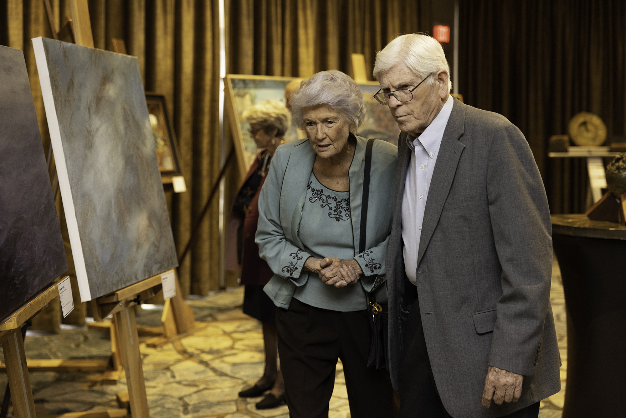 two people looking at art