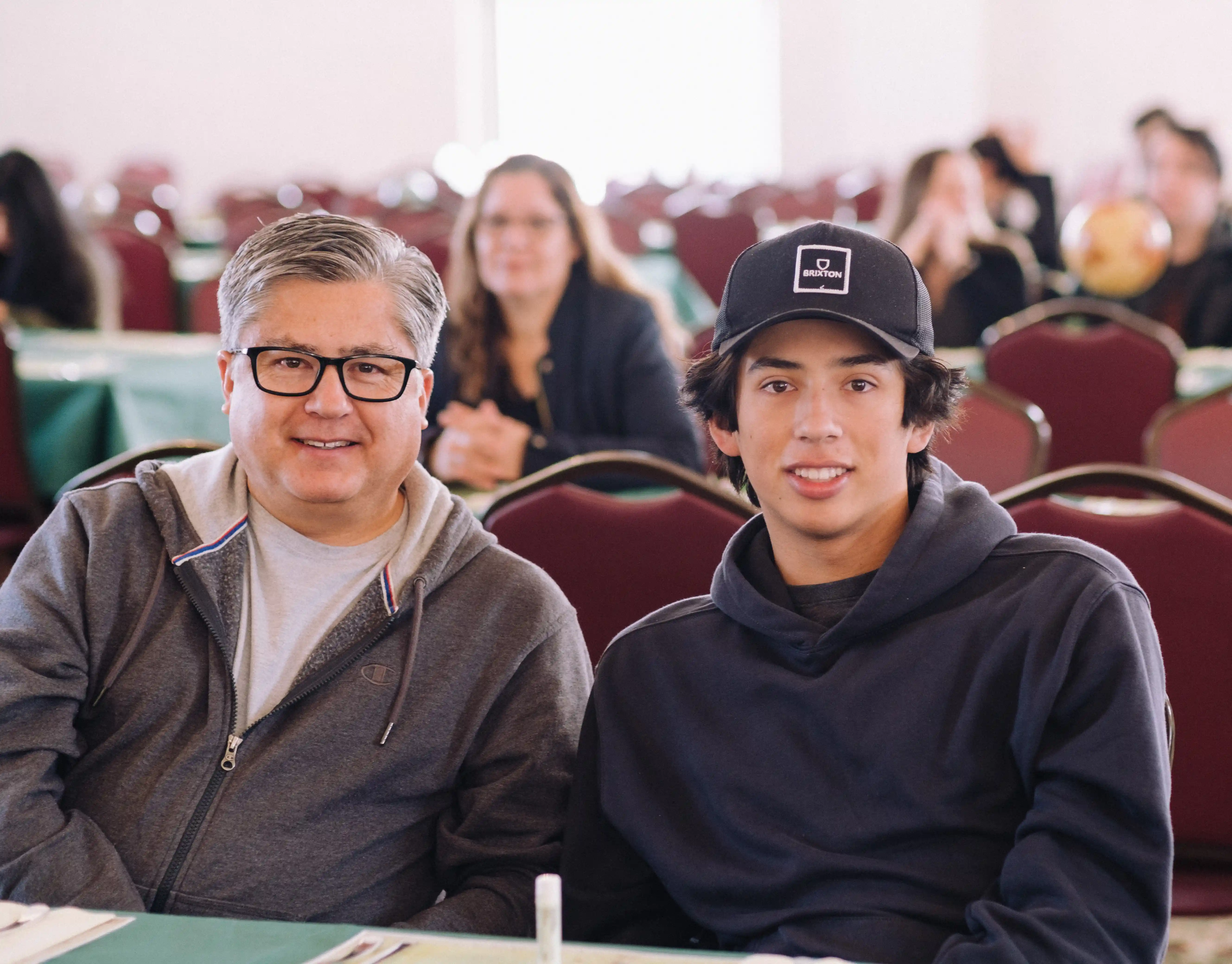 Student posing with their parent in an embrace