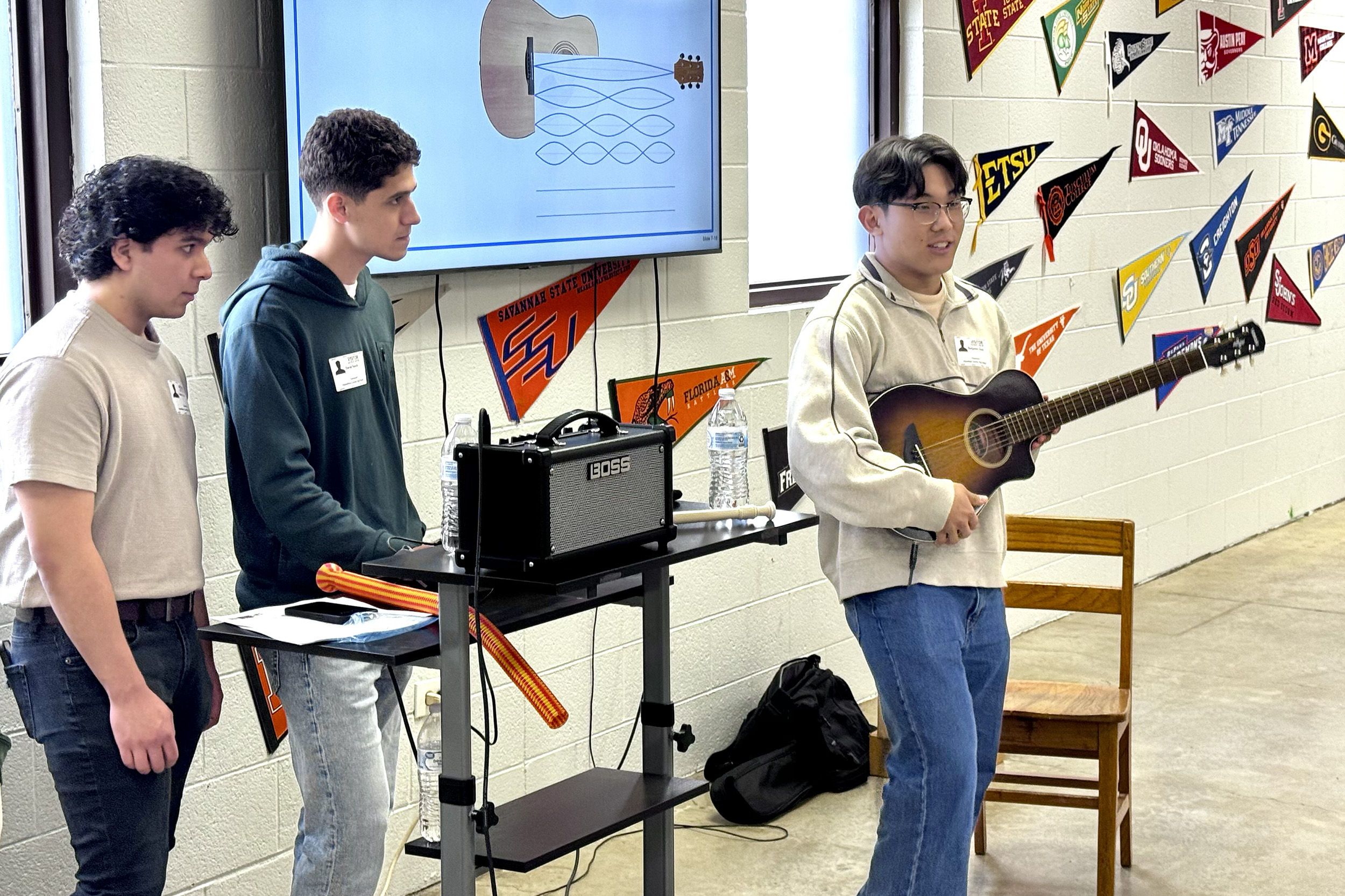 physics students teach quantum basics at a local school