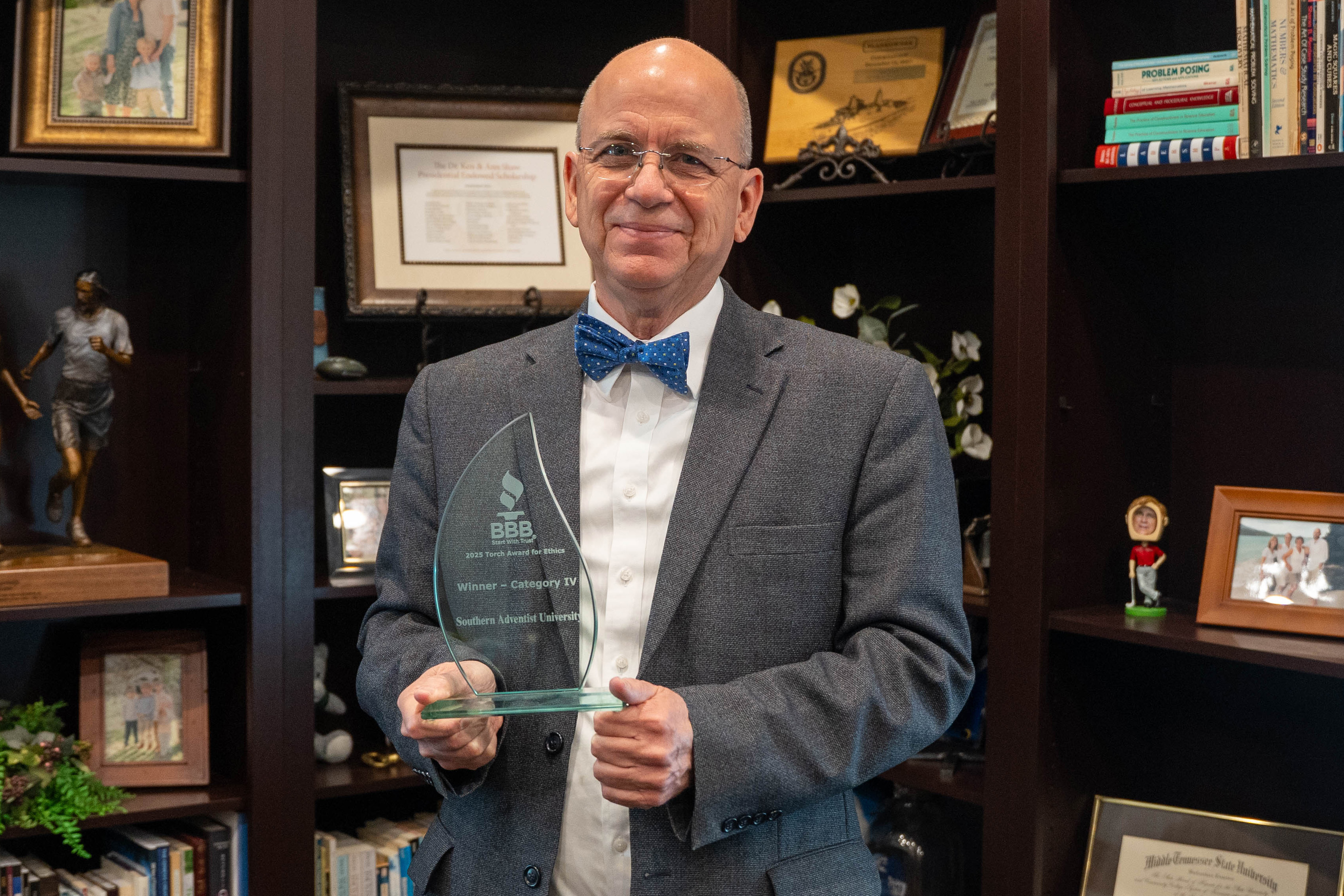 University President Ken Shaw holds the Torch Award