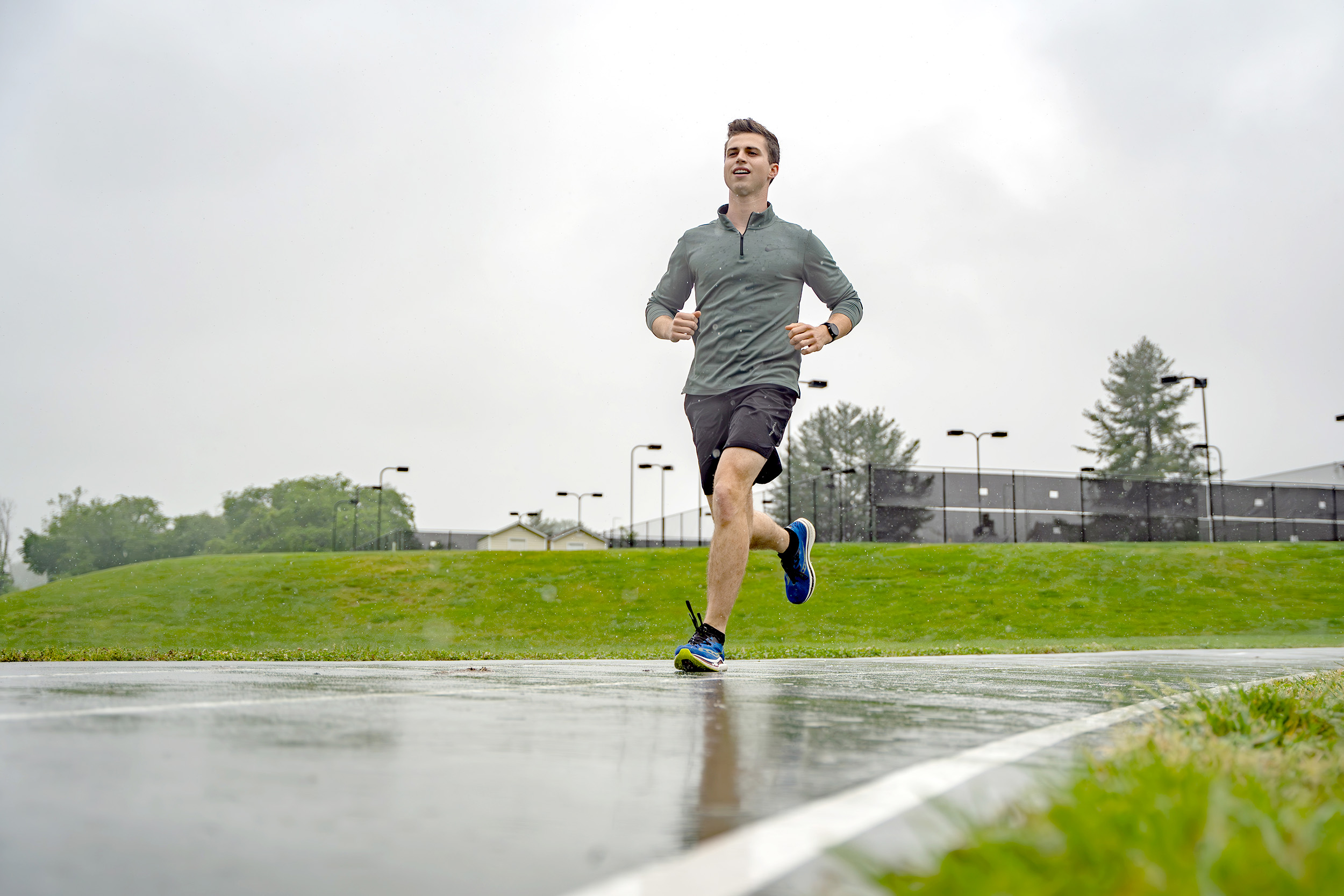 Student Cameron Guild running on Southern's track.