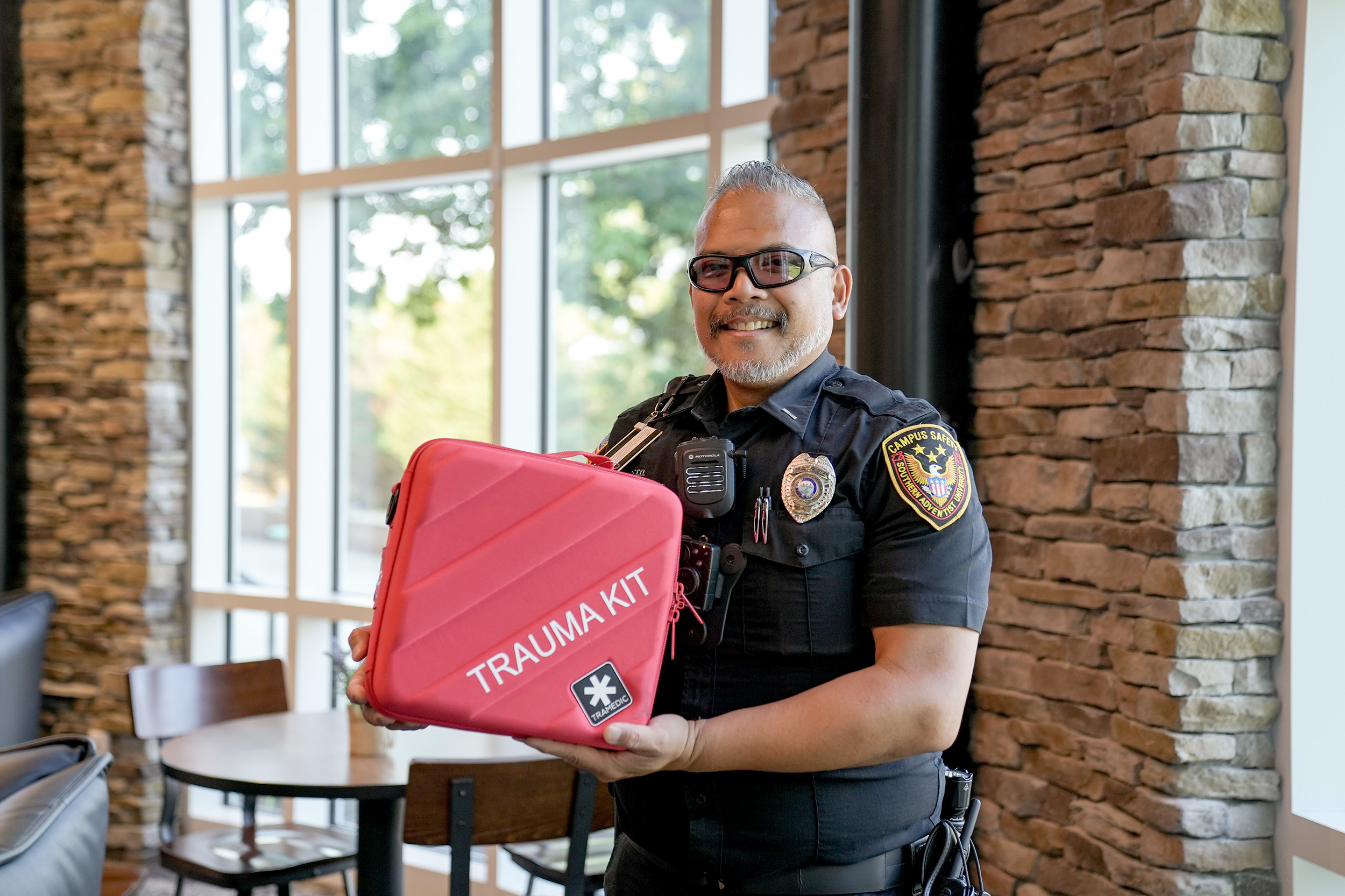 Stevenson Pangkey, campus safety patrol supervisor, shows one of the new trauma kits available on campus.